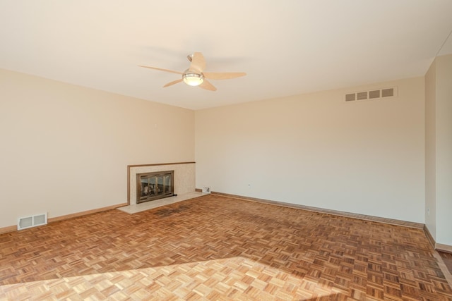 unfurnished living room featuring baseboards, a premium fireplace, and visible vents