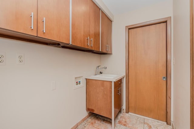 clothes washing area with washer hookup, a sink, and cabinet space