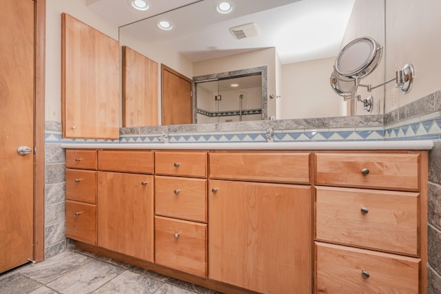 bathroom featuring double vanity and recessed lighting