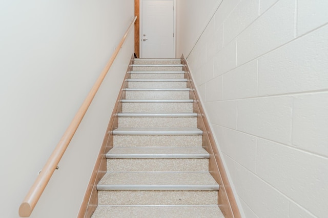 stairway with concrete block wall