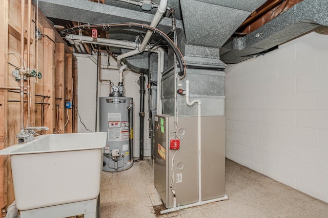 utility room featuring gas water heater, a sink, and heating unit