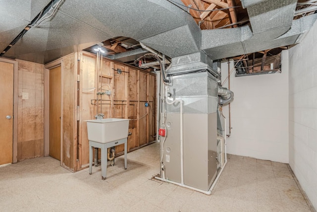 unfinished below grade area featuring tile patterned floors, concrete block wall, and heating unit