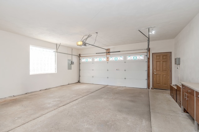 garage with electric panel and a garage door opener