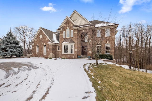 view of front of property with a yard and brick siding