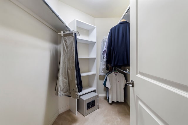 walk in closet featuring light carpet