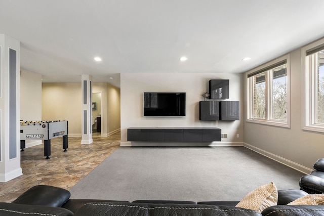 living area with baseboards and recessed lighting