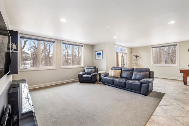 carpeted living area with a healthy amount of sunlight, baseboards, and recessed lighting