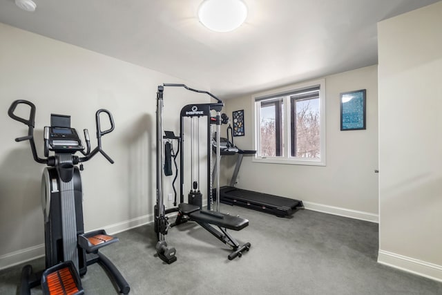 workout room featuring lofted ceiling and baseboards