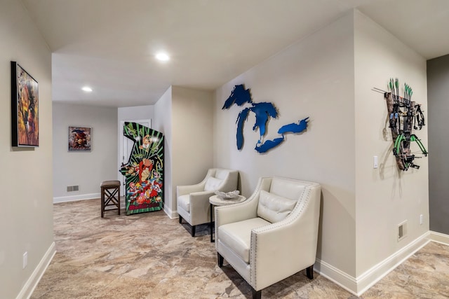 living area featuring recessed lighting, visible vents, and baseboards