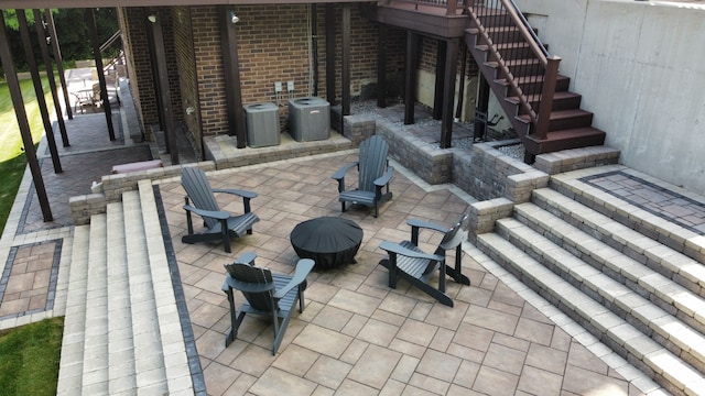 view of patio featuring central air condition unit and stairs