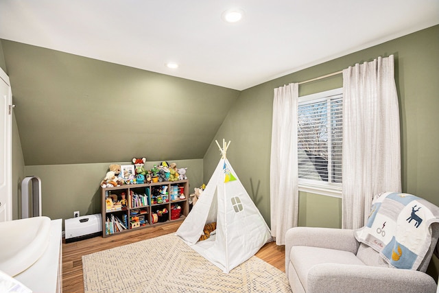 playroom with wood-type flooring and lofted ceiling