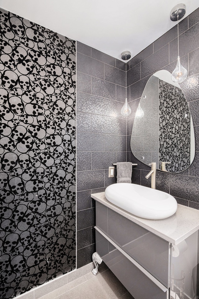 bathroom featuring vanity and tile walls