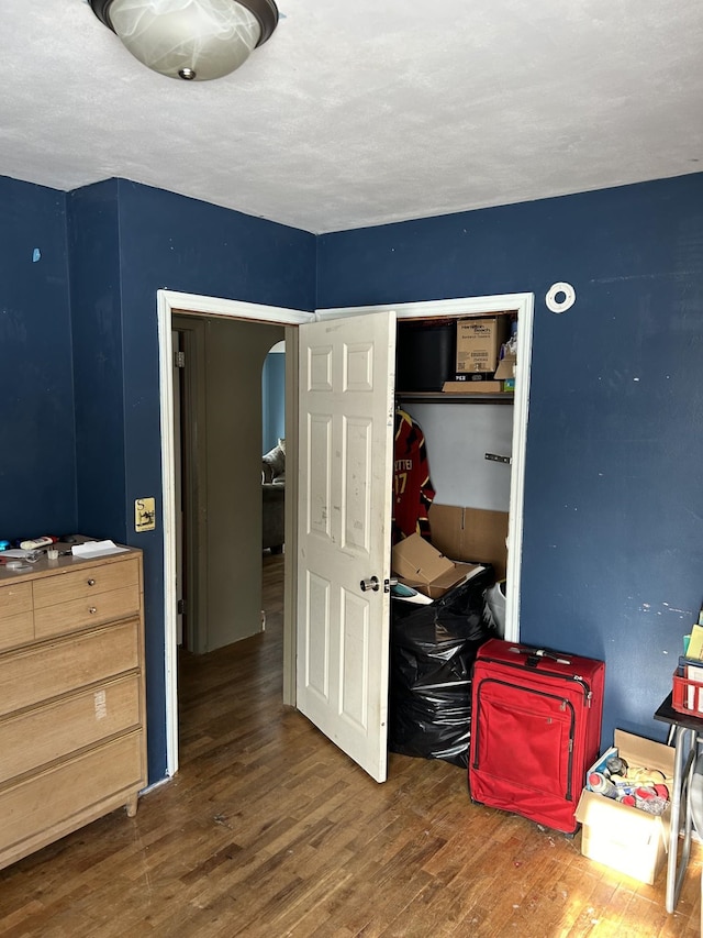 bedroom featuring dark hardwood / wood-style floors and a closet