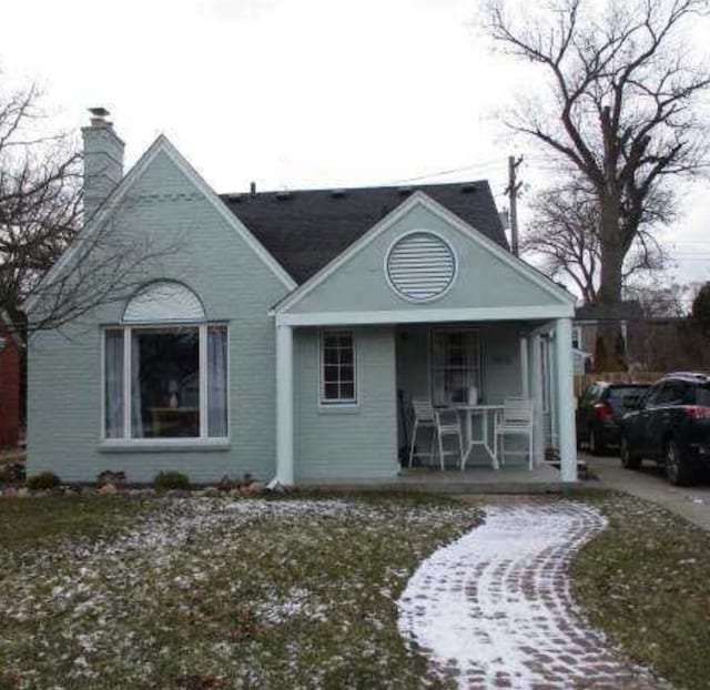 view of front of home with a porch and a chimney