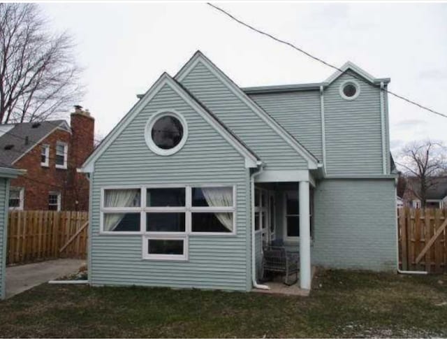 rear view of property with a lawn