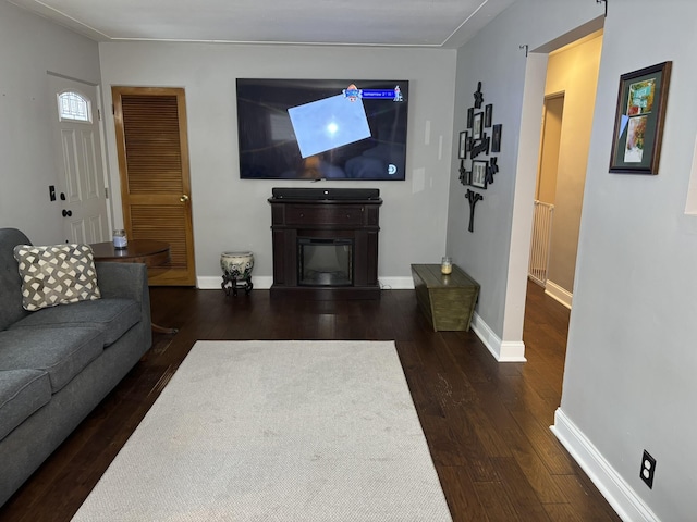 living room with dark hardwood / wood-style flooring