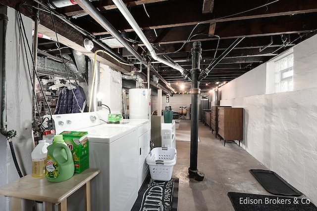 basement featuring water heater and independent washer and dryer