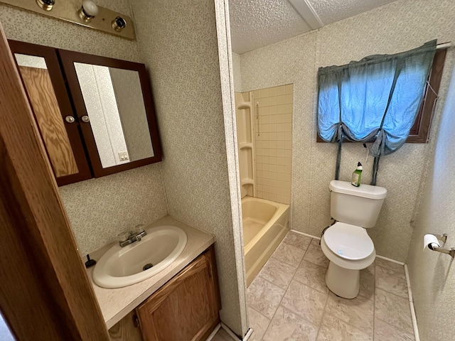 full bathroom featuring vanity, toilet, bathing tub / shower combination, and a textured ceiling