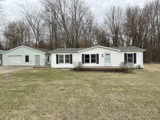 view of front of home with an outbuilding, a garage, and a front yard