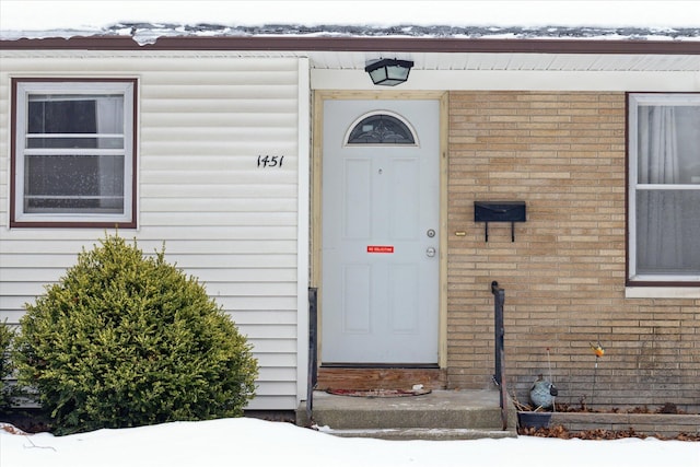 view of snow covered property entrance