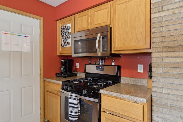 kitchen with stainless steel appliances and light brown cabinets