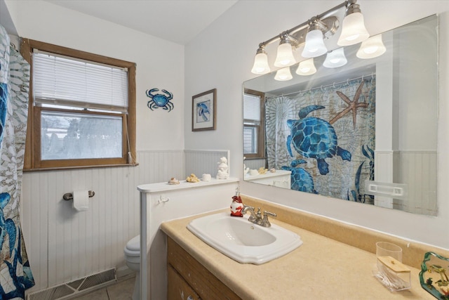 bathroom with tile patterned flooring, vanity, and toilet