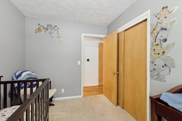 bedroom featuring light colored carpet and a closet