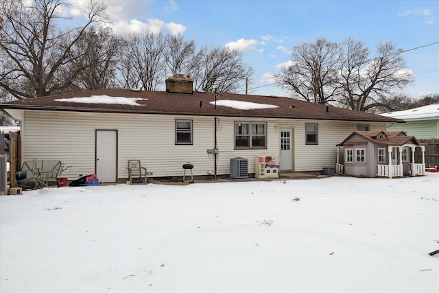 snow covered house with central AC