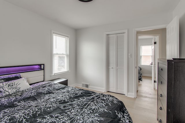 bedroom featuring light hardwood / wood-style floors and a closet