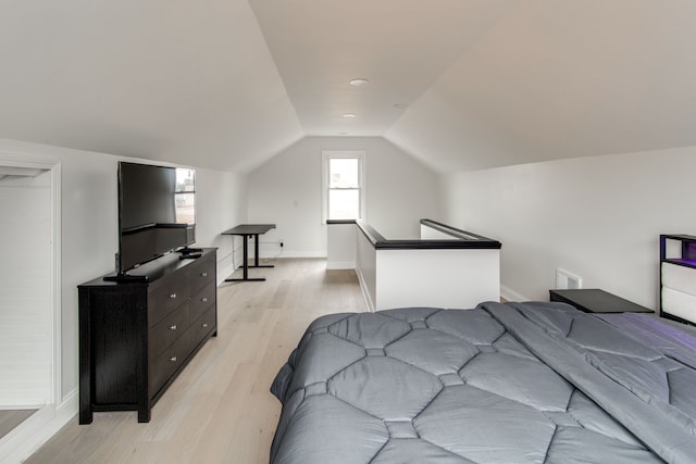 bedroom with lofted ceiling and light hardwood / wood-style flooring