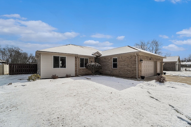 snow covered property featuring a garage