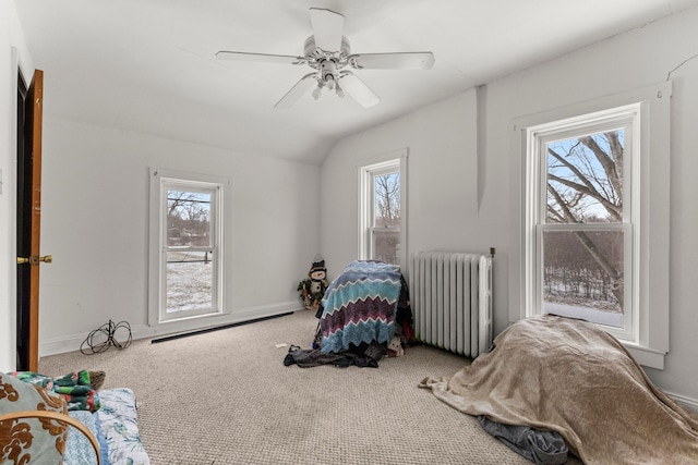 carpeted bedroom featuring radiator heating unit, ceiling fan, and vaulted ceiling