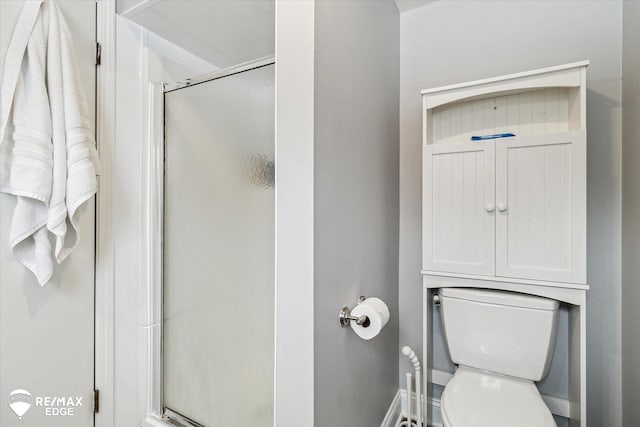 bathroom featuring an enclosed shower and toilet