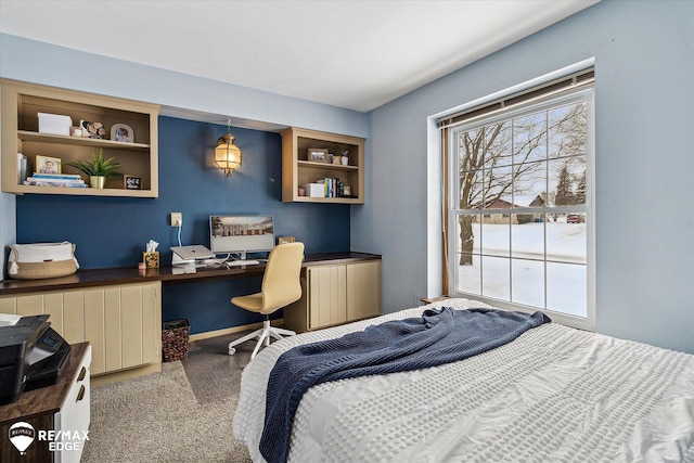 carpeted bedroom featuring radiator and built in desk