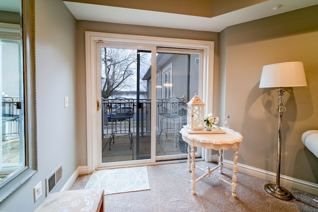 doorway featuring carpet floors