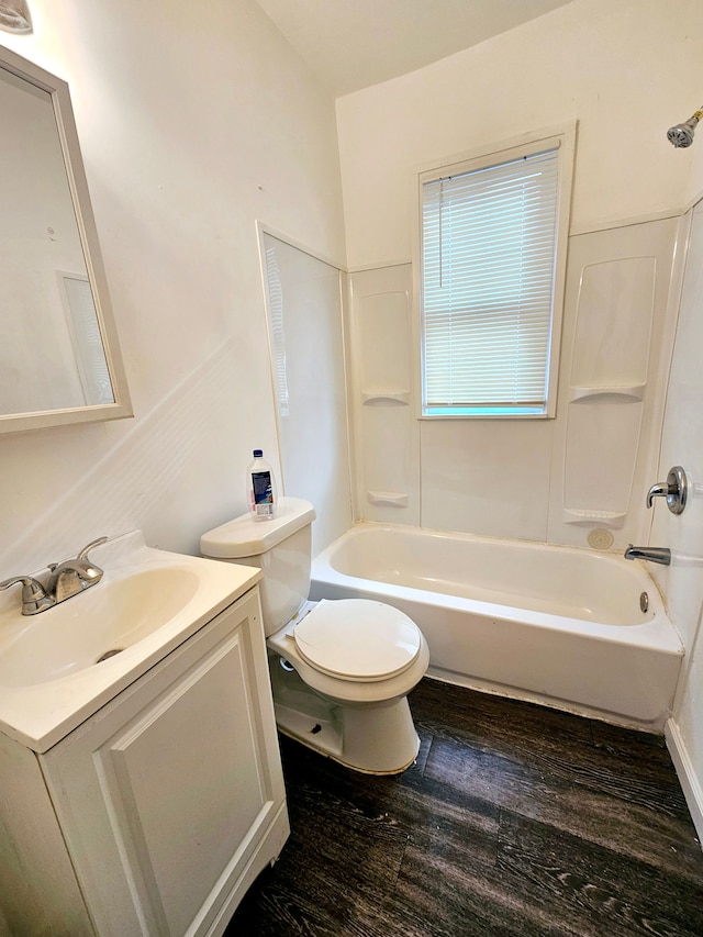 full bathroom with hardwood / wood-style flooring, vanity, bathtub / shower combination, and toilet