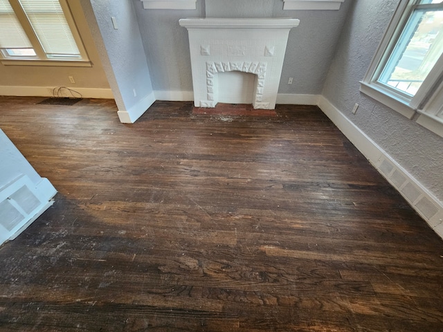 unfurnished living room featuring dark hardwood / wood-style floors