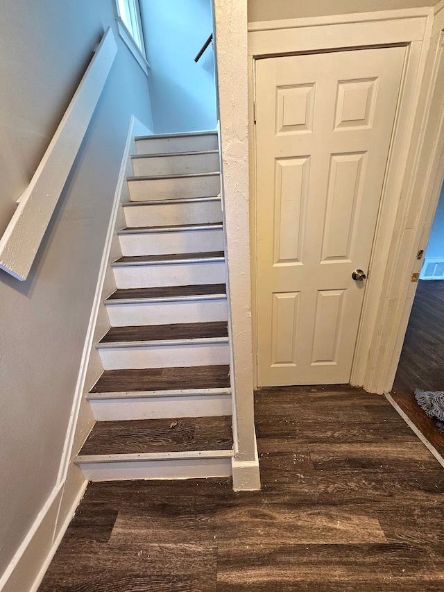 stairway featuring hardwood / wood-style flooring