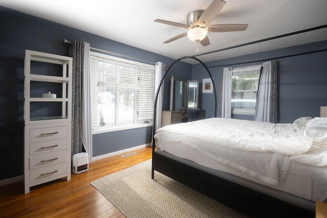 bedroom featuring hardwood / wood-style flooring and ceiling fan