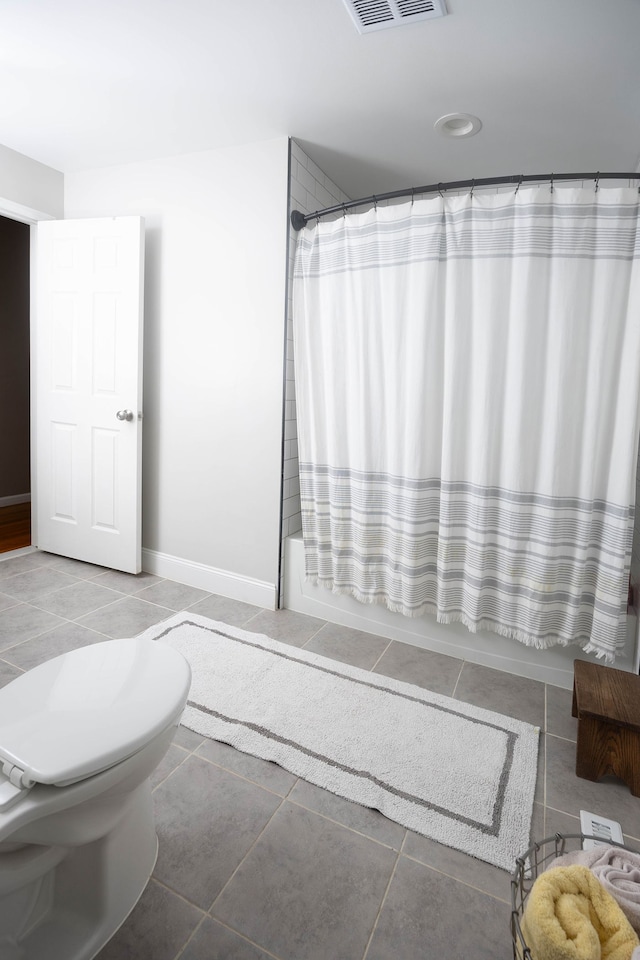 bathroom featuring tile patterned floors, toilet, and shower / bath combo