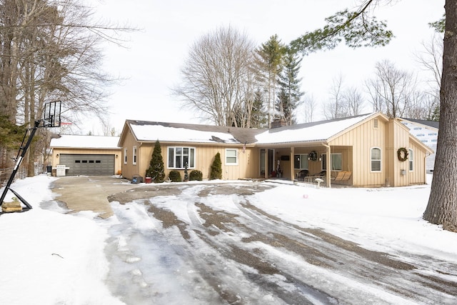 single story home with a garage and covered porch