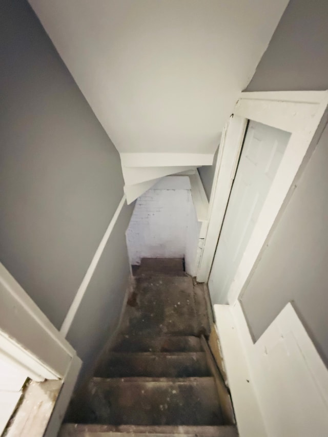 staircase featuring vaulted ceiling