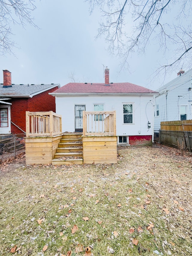 back of house featuring a wooden deck