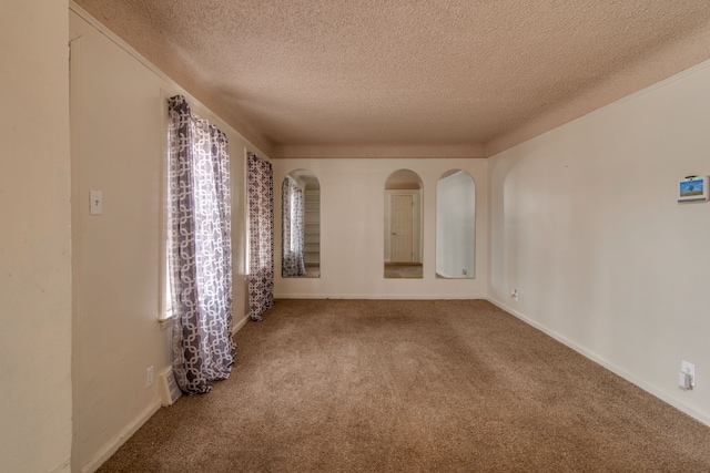 spare room with carpet floors and a textured ceiling