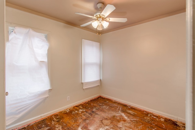 spare room with ornamental molding and ceiling fan