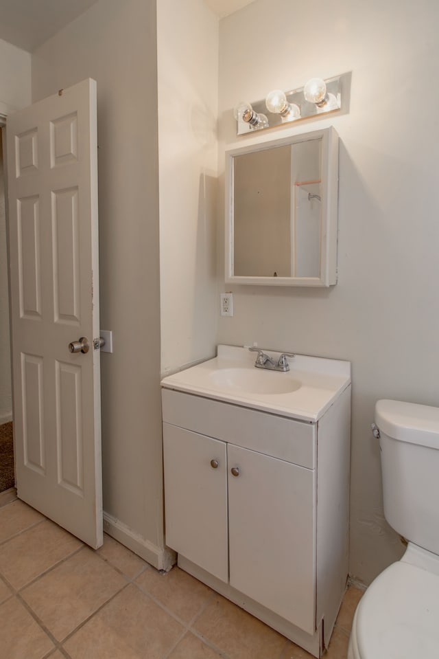 bathroom featuring vanity, tile patterned flooring, and toilet