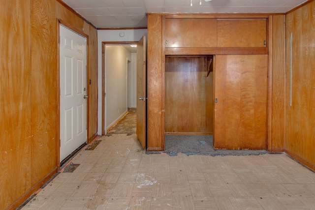 unfurnished bedroom featuring wood walls