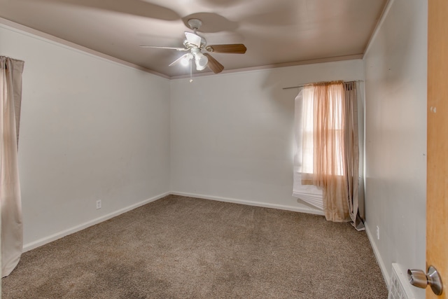 carpeted spare room featuring crown molding and ceiling fan