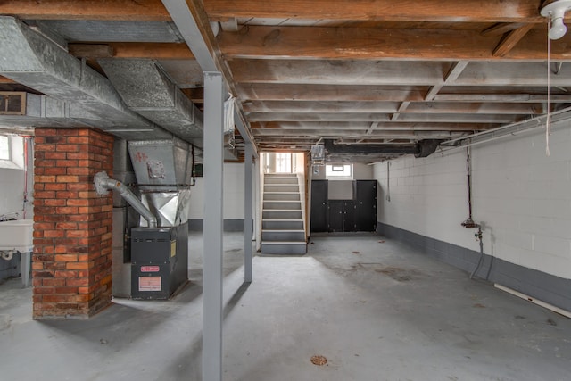 basement featuring heating unit and sink