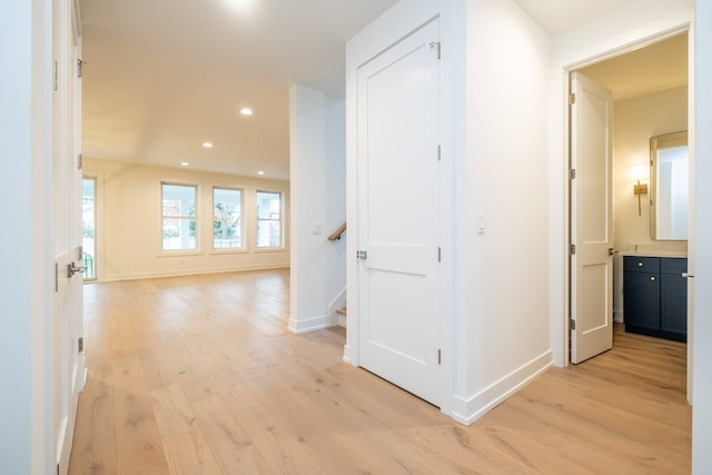 hallway with light hardwood / wood-style flooring